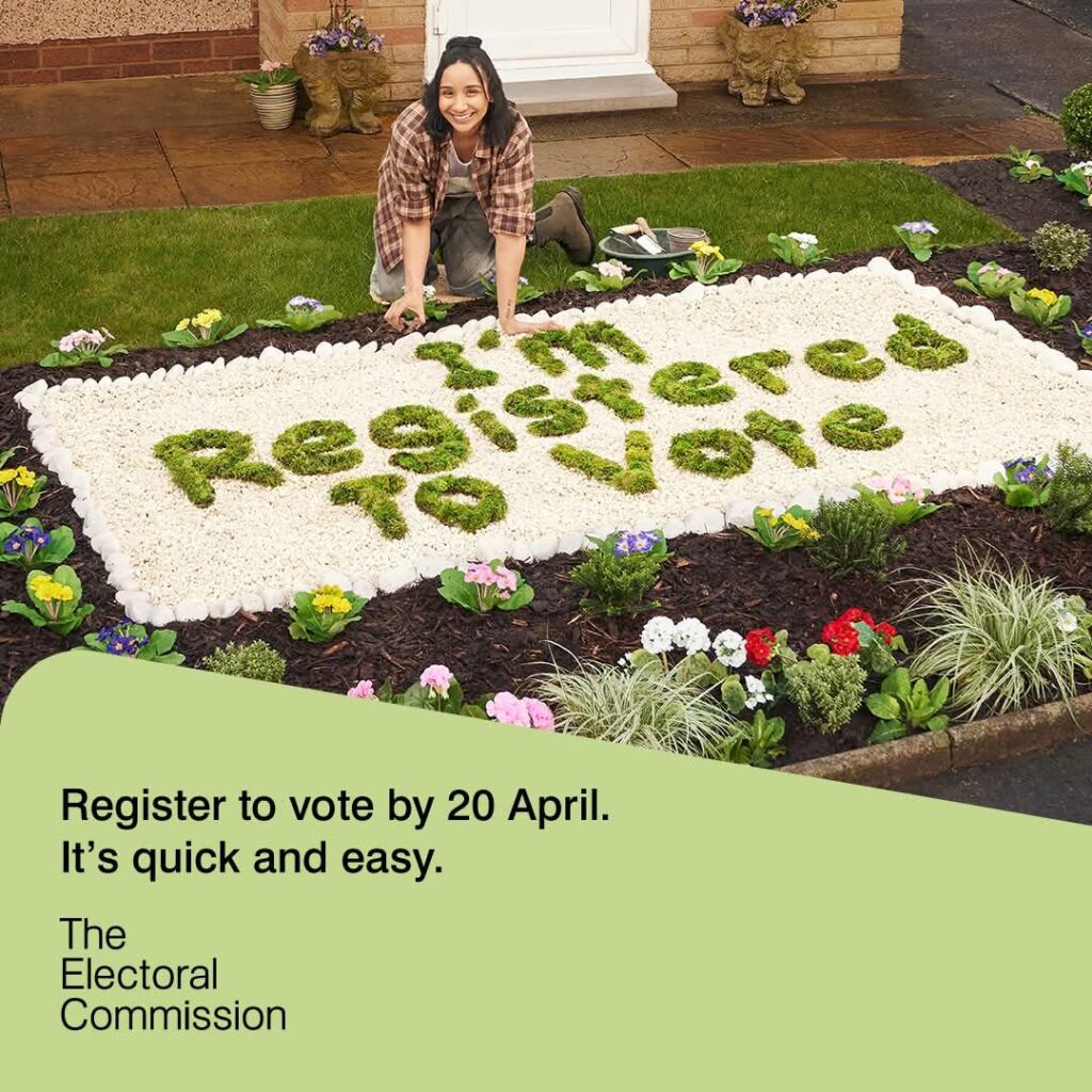 lady kneeling over a flowerbed that says I'm registered to vote